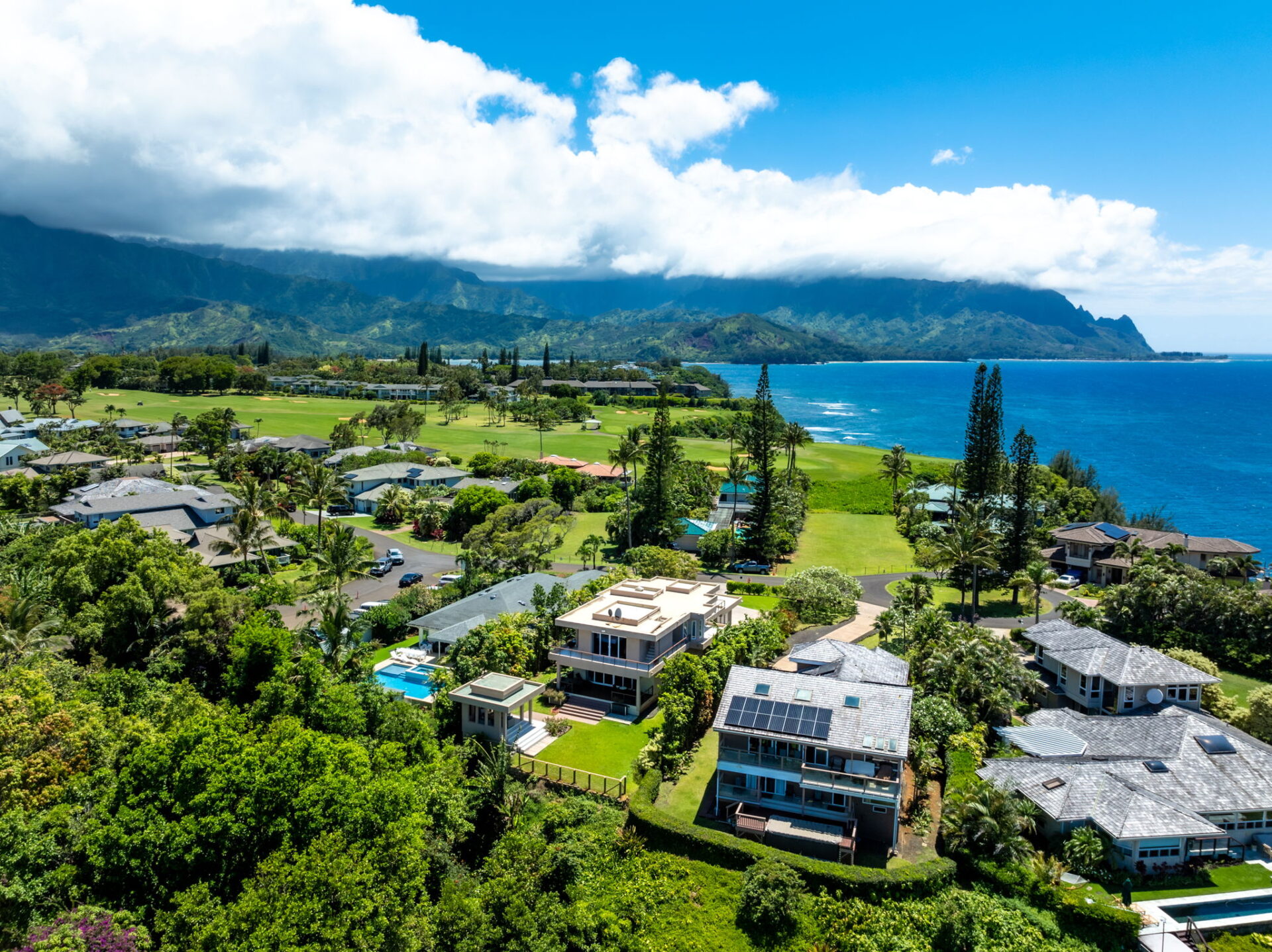 Overhead view of luxury Kauai properties featuring stunning natural landscapes and an ocean view.